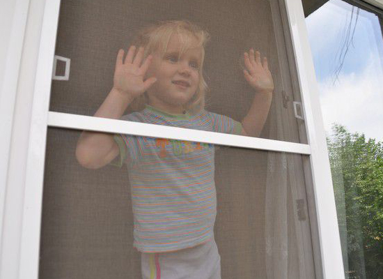 Ребенок и москитная сетка на окне